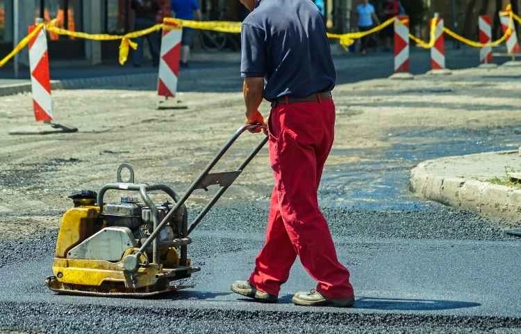 Heavy-duty road construction in Haryana with reinforced paving technology.